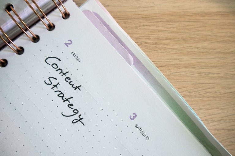 Desk with a planner with the words Content Strategy on it