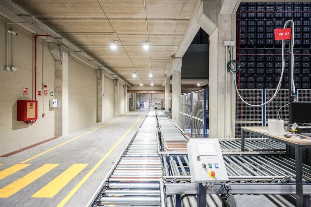 a long hallway with a lot of machines on the side of it