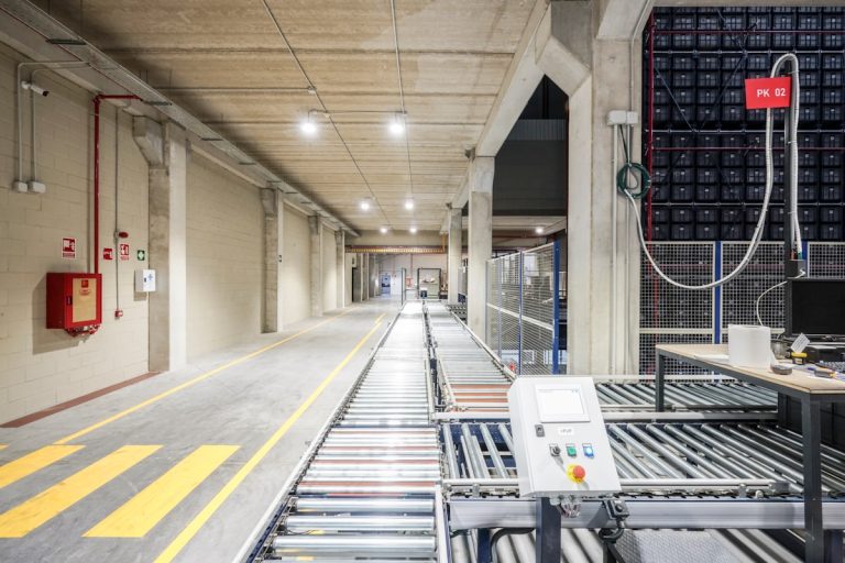 a long hallway with a lot of machines on the side of it