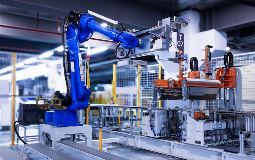 blue industrial robot arm in factory