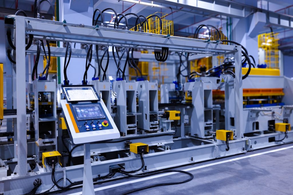 A control panel with a touchscreen on an industrial manufacturing machine in a factory