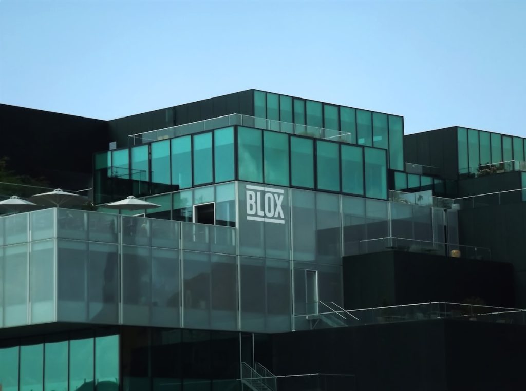 Modern building with glass facade and "blox" logo